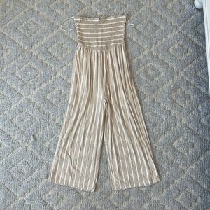 Smocked strapless jumpsuit, beige with white pin stripes. Wide leg pant